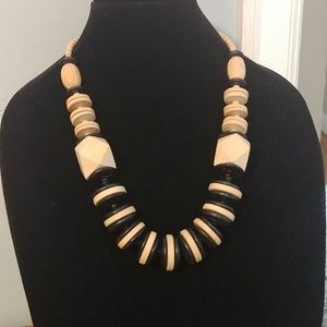 Black and tan colored 24 in wooden bead necklace.